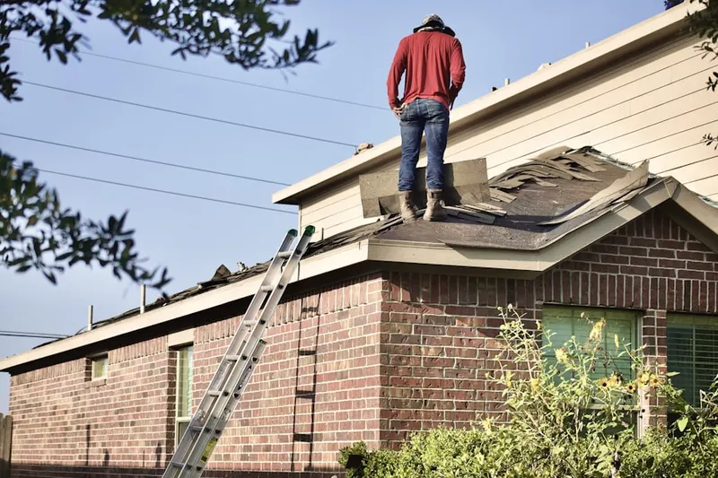 Professional roofer working on a residential roof in Tylersport